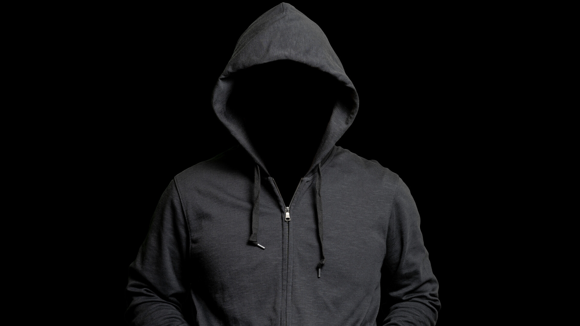 黒背景にフードを被った怪しい人物